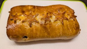 Baked golden Beef Wellington on a board