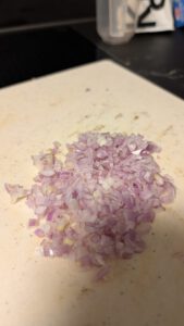 Finely diced shallots on a cutting board