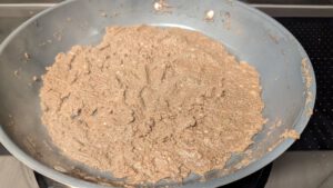 Duxelles cooked down almost dry in a pan