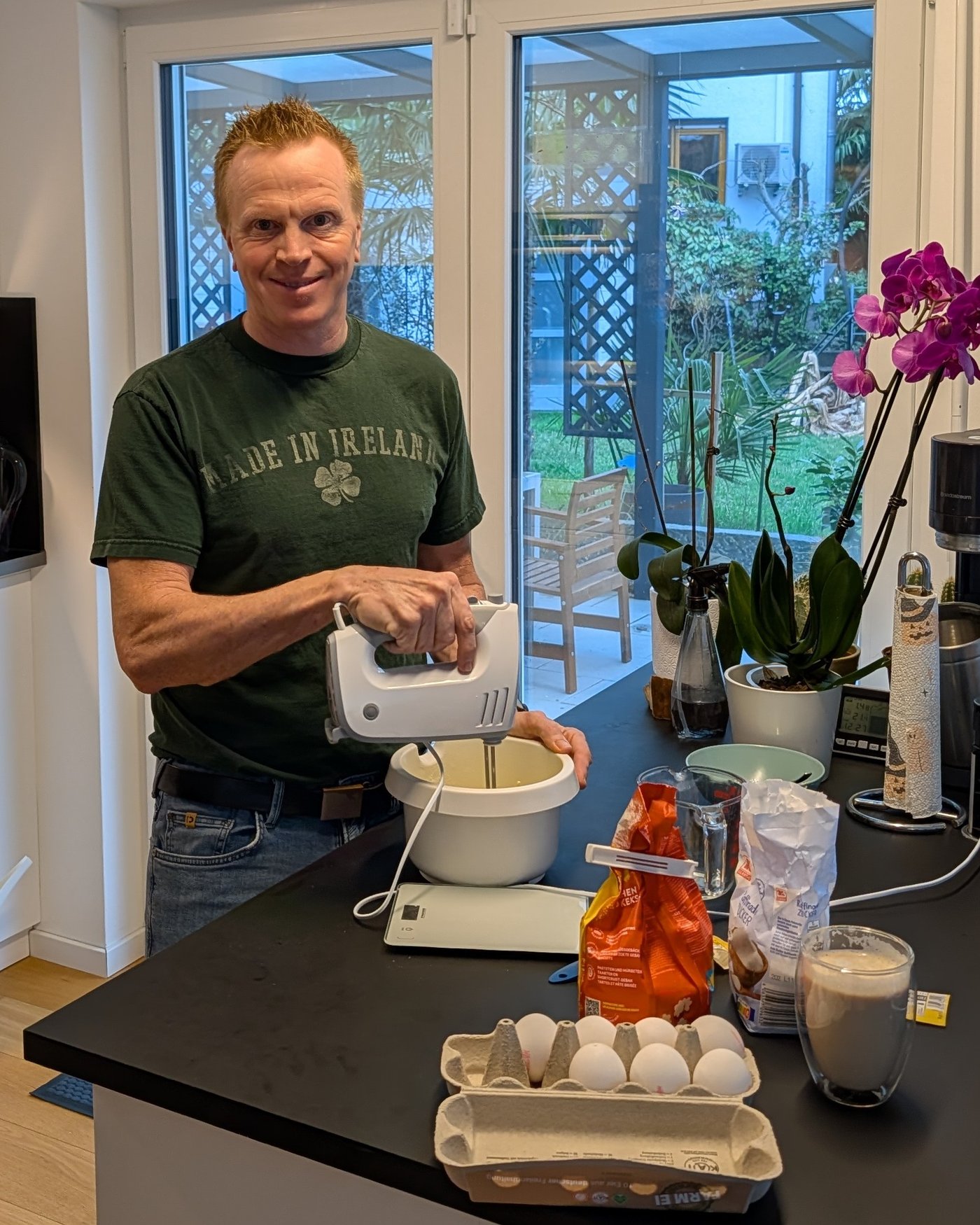 Steffen mixing a batter with a hand mixer in the kitchen, eggs and ingredients on the counter